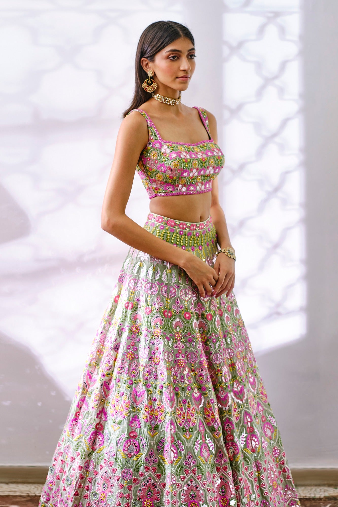 Photo of Light pink and green lehenga with contrasting tassels